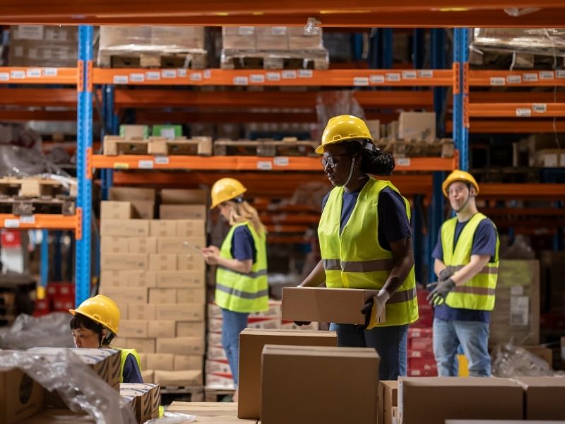 Warehouse crew handling cartons