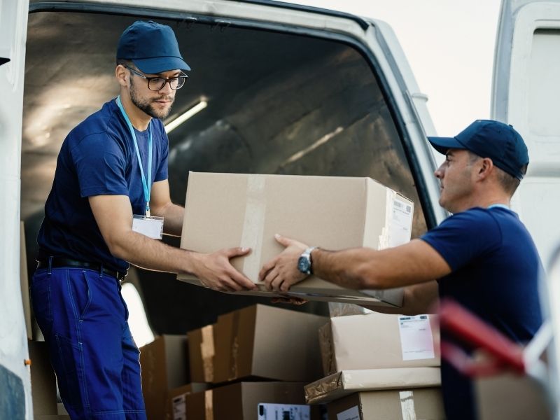 Worker handing off a delivery box